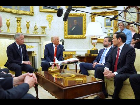 President Donald Trump (second left) meets Canadian Prime Minister Mark Carney (left) in the Oval Office of the White House yesterday.