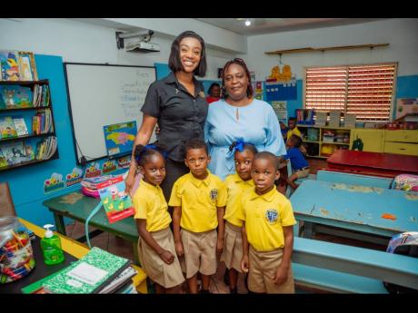 Kaydean Webley (back left), secretary, Pocket Rocket Foundation, shares a moment with Shelly-Ann Fraser-Pryce Early Childhood Institution principal Christine Powell (back right) and students (front row from left) Shana Taylor, Jordan Grant, Mikayla Beckfor