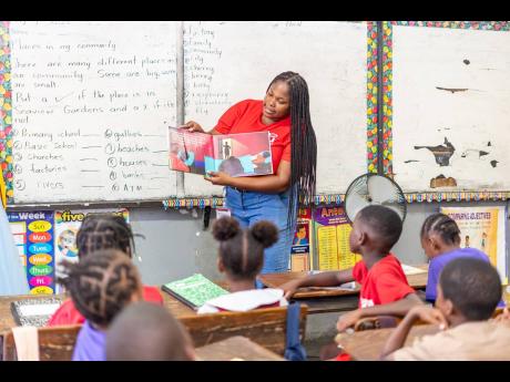 Credit: Contributed D&G Foundation volunteer Daika Mitchell captivates students during a reading session at Seaview Gardens Primary School.