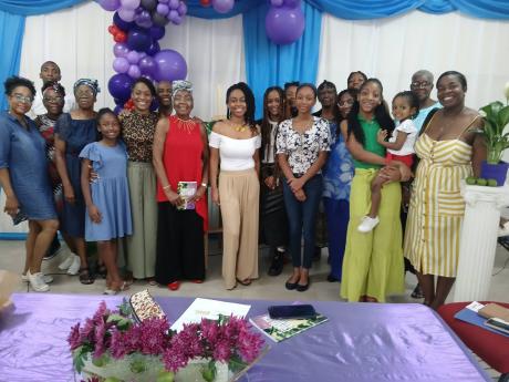 Dr Monica E. Taylor (in red top) is surrounded by her immediate family and relatives at the recent launch of her book, ‘My Juneplum Journey - Living with multiple myeloma’.