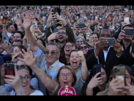 People react as the newly elected Pope Leo XIV appears on the balcony of St. Peter’s Basilica at the Vatican, Thursday, May 8.