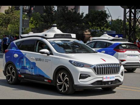 Baidu Apollo Robotaxis move on a street at the Shougang Park in Beijing.