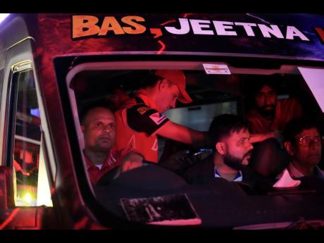 Punjab Kings’ Marco Jansen is seen wearing a cap in the bus as he leaves with team members after authorities asked for the evacuation of the  Himachal Pradesh Cricket Association Stadium in Dharamshala, India, in the middle of an Indian Premier League cr