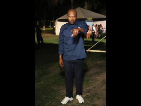 Commanding and classic in navy, Agent Sasco pauses backstage for a quick snap.
