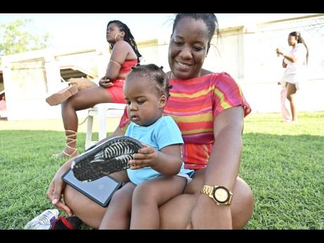 Grace Esson, administrative officer, with daughter Daiwik Esson at an event recognising 180 years since the arrival of Indians in Jamaica at Chedwin Park in St Catherine on Sunday.
