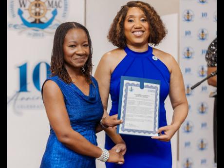 Dr Velma Ricketts Walker (right), CEO and commissioner of Customs, receives an honorary certificate of induction from Valrie Campbell, chapter chair of the Women in Maritime Association, Caribbean, during the organisation’s 10th anniversary gala held at 