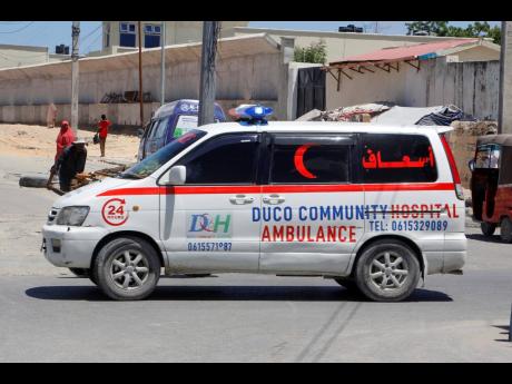An ambulance is seen near the scene of a bomb attack in Mogadishu, Somalia Sunday, May 18, 2025. (AP Photo/Farah Abdi Warsameh)