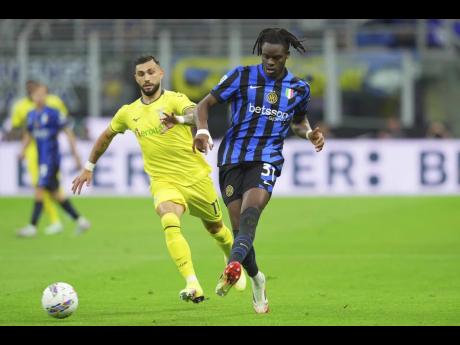Credit: AP Inter Milan’s Yann Bisseck (right) fights for the ball with Lazio’s Taty Castellanos during the Italian Serie A match at San Siro Stadium in Milan, yesterday.