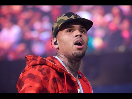 In this June 7, 2015 file photo, Chris Brown performs at the 2015 Hot 97 Summer Jam at MetLife Stadium in East Rutherford, N.J. (Photo by Scott Roth/Invision/AP, File)