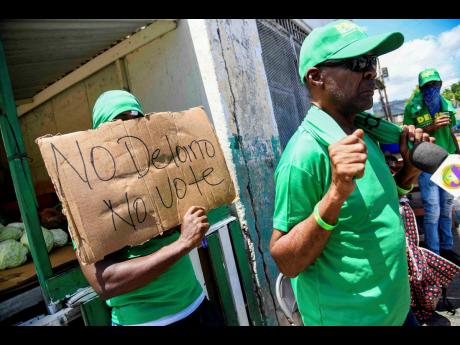 Michael Dennis, a JLP supporter for the past 49 years, speaks during an interview with the media as JLP supporters from North Central St Andrew stage a protest along Shortwood Road in St Andrew on Monday, May 19.