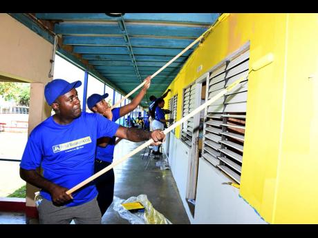 Hugh Miller, interim managing director of JN Fund Managers, and team members painting the walls of the Salvation Army School for the Blind and Visually Impaired in Kingston on Labour Day. The JN Fund Managers’ volunteers also renovated the quadrangle, an