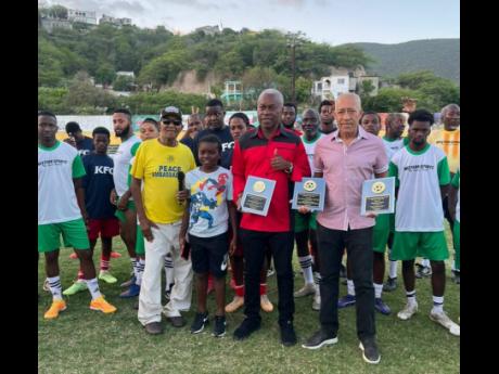 Women’s football coach Charles Edwards (right) and attorney-at-law Bert Samuels (second right) pose with their plaques, alongside Safari Samuels and ‘Bring Back The Love’ organiser Clive ‘Busy’ Campbell (left), at the ‘Bring Back The Love’ fo