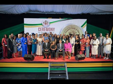 Prime Minister, Dr. Andrew Holness (seated, second right), shares a photo opportunity with the 2024 recipients of the Prime Minister’s Medal of Appreciation for Service to Education, during Wednesday’s awards ceremony, on the lawns of Jamaica House. Al