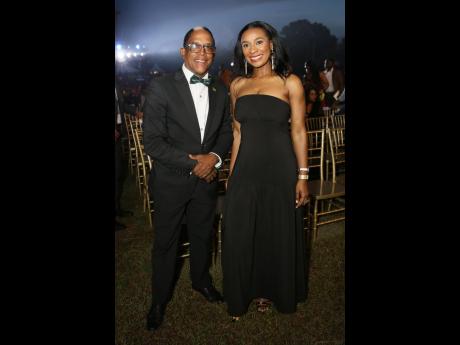 Dr Norman Dunn (left), state minister in the Ministry of Labour and Social Security, dons a black tux as he poses with an elegant Dr Taneisha Ingleton, managing director, HEART/NSTA Trust .