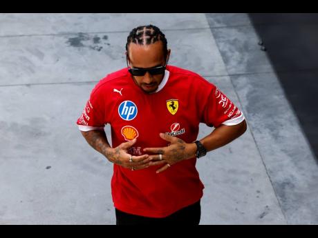 Credit: AP Ferrari driver Lewis Hamilton of Britain walks through the paddock before the Spanish Grand Prix Formula One race at the Barcelona Catalunya racetrack in Montmelo, near Barcelona, Spain, yesterday.