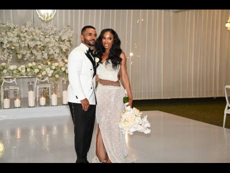 Below: Thomas holds his bride Jodae close, as they continue their celebrations at the reception.