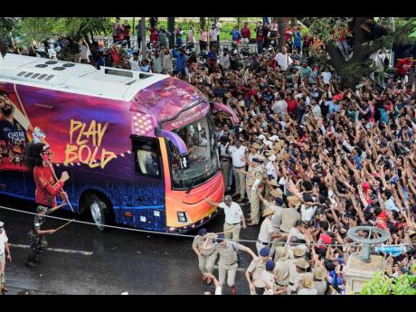 Fans cheer as the bus carrying Royal Challengers Bengaluru cricketers, winners of the Indian Premier League, arrive at the M Chinnaswamy Stadium in Bengaluru, India, Wednesday, June 4, 2025. (AP Photo/Aijaz Rahi)