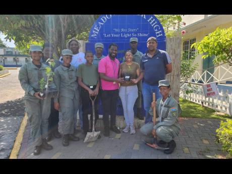 Andrew Hinds (centre), Forest Manager, South East Region at the Forestry Department, cadets and staff of the Meadowbrook High School get ready for their tree-planting project on the compound to celebrate Labour Day.