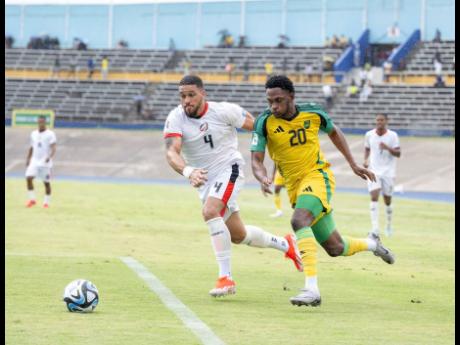 Jamaica’s Renaldo Cephas (right) making a run at goal, contested by Tayvon Gray of Dominica Republic during a Concacaf World Cup Qualifying football game at the National Stadium on Thursday, June 6, 2024. 