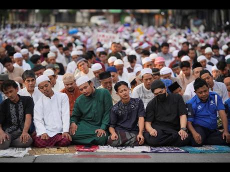 Muslims perform Eid al-Adha prayer on a street in Jakarta, Indonesia on Friday.
