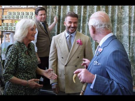 
Britain’s King Charles III and Queen Camilla speak with David Beckham at the Chelsea Flower Show in London on May 19.