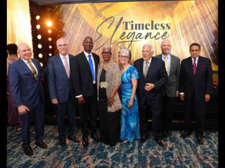 Kingston Wharves Chairman Jeffrey Hall (left); CEO Mark Williams (third left) and other directors celebrate with Solid Foundation Awardees Charles Johnston (third right) and Grantley Stephenson (right). Other directors (from left) are Robert Scavone, Kathl