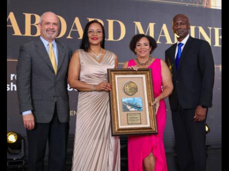 Kingston Wharves’ (KWL) Group Chief Financial Officer Clover Moodie (second left), presents Seaboard Jamaica’s CEO Corah-Ann Sylvester (second right) with the Lifetime Partner Award for that shipping line’s continued investment and partnership with K