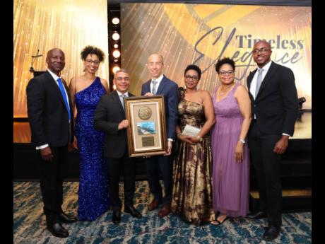 Kingston Wharves Limited (KWL) presents officials of Höegh Autoliners with a Solid Alliance Award for that company’s collaboration in its auto transshipment business. KWL’s CEO Mark Williams (left) shares in the moment with Höegh’s trade manager, S