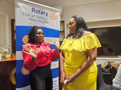 Credit: Contributed Debra-Ann Matthews (left), president, Trafalgar New Heights Rotary Club, is in deep discussions with Deon Graveney, financial advisor, JN Life Insurance, at a recent meeting of the Trafalgar New Heights Rotary Club at Cru Bar in St Andrew.