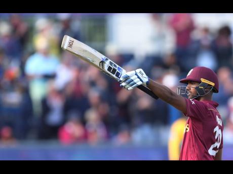 West Indies’ batsman Nicholas Pooran raises his bat to celebrate scoring a century during the Cricket World Cup match between Sri Lanka and the West Indies at the Riverside Ground in Chester-le-Street, England, on Monday, July 1, 2019. 
