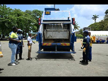 National Solid Waste Management Authority personnel give a demonstration during a National Solid Waste Day exposition. 
