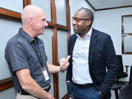 Alan Brandshaw, Vice President of Utility Relations at Holland Power Services, and Hugh Grant, President and CEO of JPS, in a chat on Monday, June 9. Holland Power Services is one of the contracting firms on standby to support JPS in its restoration effort