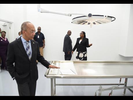 Credit: Ian Allen/Photographer Dr Horace Chang, deputy prime minister and minister of national security, tours the Forensic Pathology Autopsy Suite shortly after the official opening in Kingston on Thursday.