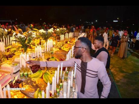 Dr Kirt Henry, director of the African Caribbean Institute of Jamaica/Jamaica Memory Bank, participates in the ceremonial lighting of candles at the inaugural National Revival Conference and Church Service, held at the Ranny Williams Entertainment Centre o
