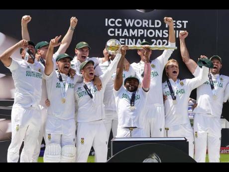 
South Africa’s captain Temba Bavuma holds the winner’s trophy as he celebrates with teammates after their win in the World Test Championship final against Australia at Lord’s cricket ground in England on Saturday, June 14, 2025.