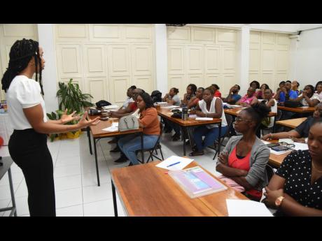 Britney Aiken (left), speech and language pathologist, Mico, engages with attendees during a Mico CARE Centre Speech Intervention workshop for parents. The workshop was held at the Mico Care Centre in Kingston last year.
