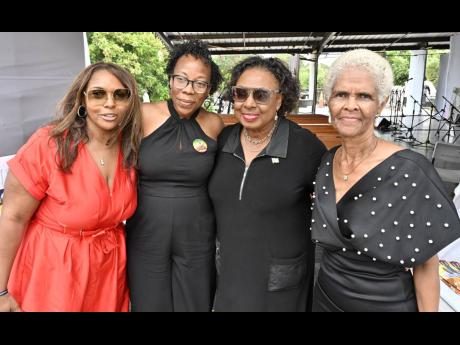 Credit: Rudolph Brown From left, Junior Byles’s daughters Kamella and Sheryl, Minister Grange and Byles’s sister Deyanne.