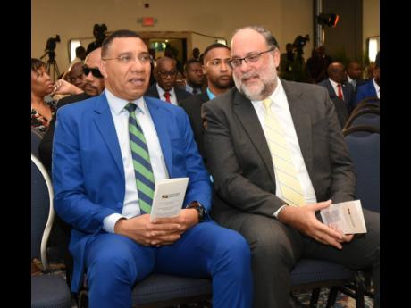 Prime Minister Dr Andrew Holness (left) and Opposition Leader Mark Golding at the 45th Annual National Leadership Prayer Breakfast. 