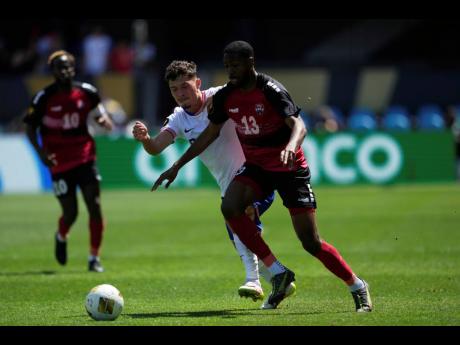 Trinidad and Tobago midfielder Tyrese Spicer (right) dribbles away from United States midfielder Sebastian Berhalter during the first half of a CONCACAF Gold Cup football match in San Jose, California on Sunday.