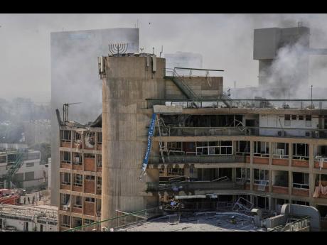 Smokes rises from a building of the Soroka hospital complex after it was hit by a missile fired from Iran in Beersheba, Israel, Thursday, June 19.