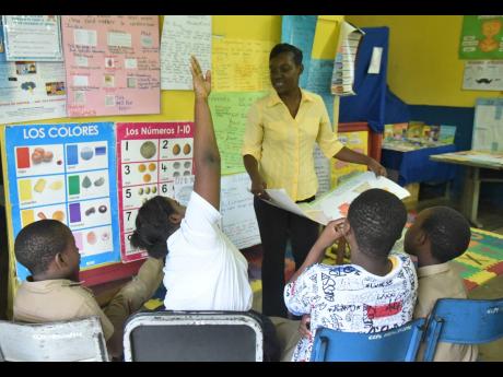 Credit: Ian Allen/Photographer Julane King-Walker, provisional principal of Claverty Cottage Primary School in Portland, conducting an exercise with four of the five students attending the school lst November.