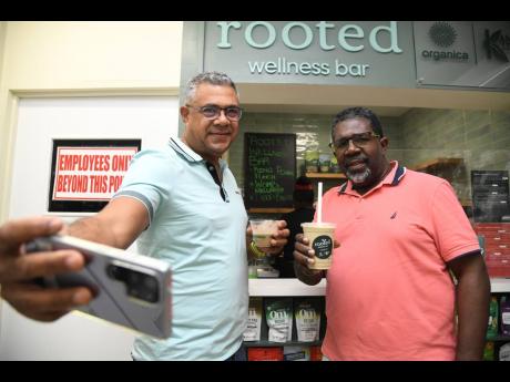 Credit: Antoine Lodge Krishna Phillips (left), director of Organica Whole Foods, grabs a selfie with Dr Wayne Brown at the launch of the Rooted Wellness Bar.