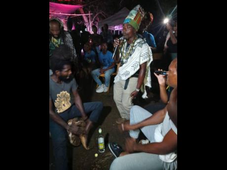 Well-known Kumina practitioner Bongo Shem (with mic) is in an intense moment during ‘Bun Fire Night’.