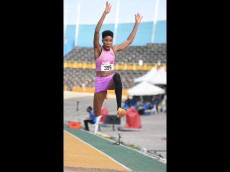 Shanieka Ricketts jumps her way to her seventh national title at the National Junior and Senior National Championships at the National Stadium yesterday.