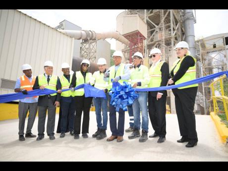 Alejandro Ramirez (fifth left), Cemex regional president for South, Central America and the Caribbean Region, cuts a ribbon with Prime Minister Dr Andrew Holness (fourth right) to officially commission Carib Cement’s Debottleneck Project, at its Rockfort