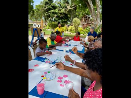 Family members of clients participate in a painting exercise led by Bellevue Hospital’s Occupational Therapy Department during the paint-and-sip session at the Family Day event.