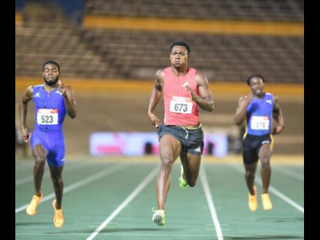 Defending champion Bryan Levell (centre) powers home to retain his men’s 200 metres title on yesterday’s final day of the JAAA National Senior and Junior Championships at the National Stadium. Levell won in 20.10 seconds, while Christopher Taylor (left