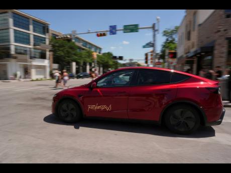 Credit: AP A driverless Tesla robotaxi on the streets of Austin, Teaxs, June 22, 2025.