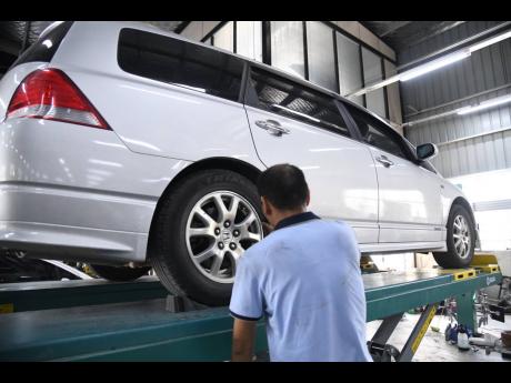 One the Chinese national workers at Whole Hearted Car Service station in St Catherine last April. 
