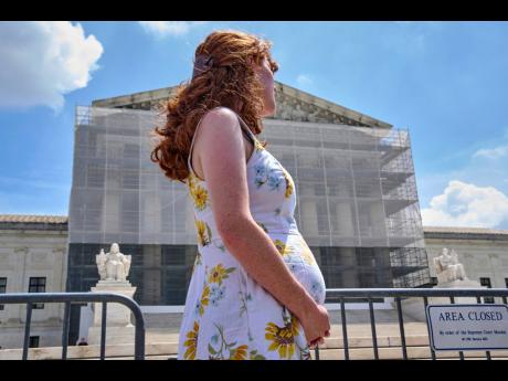 Mairelise Robinson, a US citizen who is six months pregnant, attends a protest in support of birthright citizenship, outside of the Supreme Court in Washington, May 15, 2025. (AP Photo/Jacquelyn Martin, File)